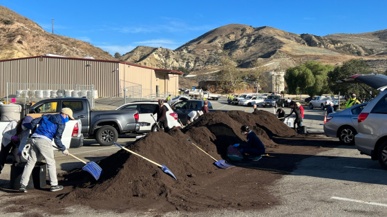 OC Waste & Recycling employees shoveling compost
