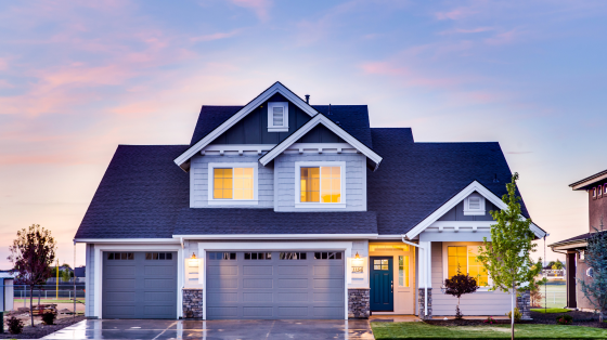 a nice house with a garage at sunset
