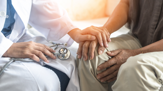 picture of a doctor's hand reaching out to a patient