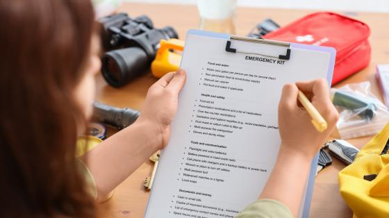 Woman reviewing an emergency preparedness checklist.