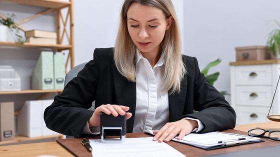 Image of a woman providing apostille service with a stamp