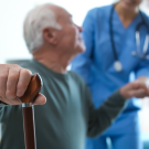 Care Worker Helping Elderly Man in Geriatric Hospice