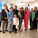 (Left to Right) Kevin Onuma, OC Public Works Director, Chair Doug Chaffee, Fourth District Supervisor, a family from Santa Ana, Hugh Nguyen, Clerk-Recorder, Vice Chair Katrina Foley, Fifth District Supervisors, Shari Freidenrich, Treasurer-Tax Collector, Kimberly Engelby, Chief Financial Officer, and Dylan Wright, OC community Resources Director.