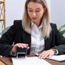Image of a woman providing apostille service with a stamp